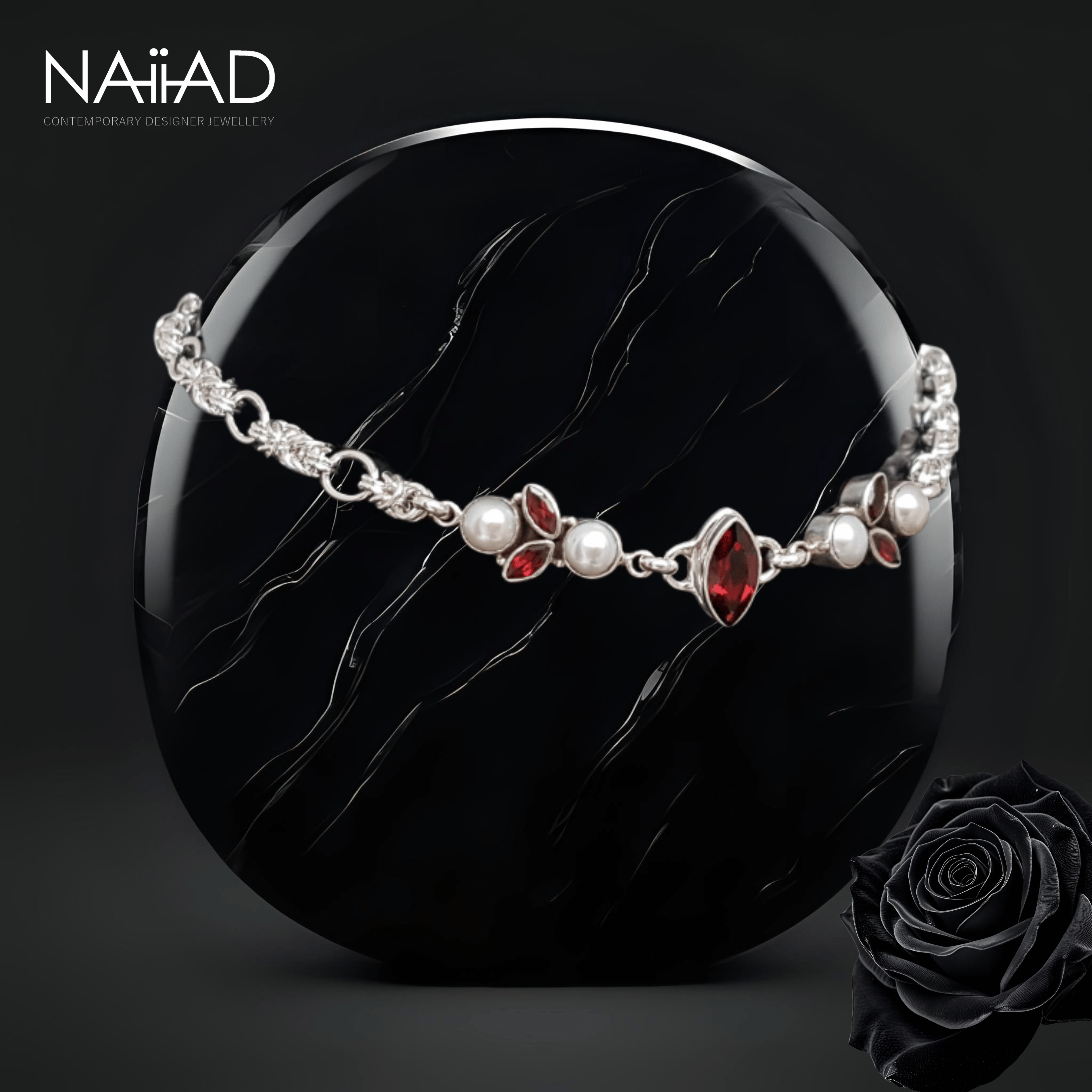 Handmade sterling silver choker necklace with garnet and freshwater pearls, side view on black stone. Customisable silver jewellery for the bride and mother of the bride